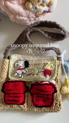 a crocheted bag with two stuffed animals on it and the words snoopy inspired bag