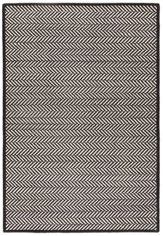 a black and white rug with herringbones on the bottom, in an angled pattern