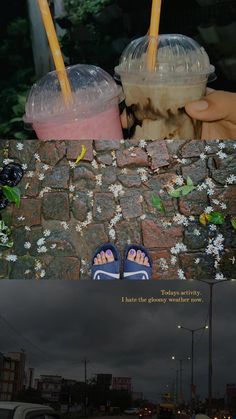 two cups with drinks in them sitting on top of a stone wall next to a person's feet