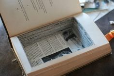 an open book sitting on top of a table next to a pair of orange scissors