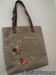 a handbag hanging on the wall with flowers painted on it's front and side