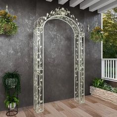 an arch in the middle of a patio with potted plants on it and two hanging planters