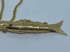 Vintage gilt  light weight new old stock articulaed fish pendant from the 70's on a 24 inch chain  total weight 5 grams  pendant 60cm long aprx. Luxury Gold Fish-shaped Necklace, Luxury Yellow Gold Fish-shaped Necklace, Articulated Fish Pendant, Fish Bracelet, Articulated Fish, St Christopher Pendant, Fishing Bracelet, Fish Necklace, Fish Pendant