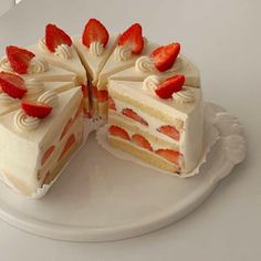 a cake with white frosting and strawberries on top