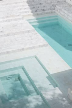 an empty swimming pool with steps leading up to it