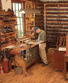 a man standing in front of a workbench filled with lots of woodworking tools