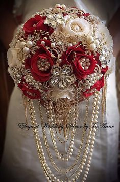 a bridal bouquet with red roses and pearls