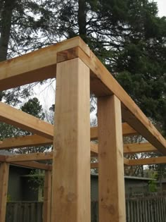 a wooden structure sitting in the middle of a yard