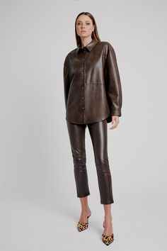 Elements of ease. The Jaedon Vegan Leather Shirt strikes function and fashion in a minimalist vegan leather design with a cool oversized fit, dropped shoulder, tortoiseshell button-down front and a standard collar. SIZING: Oversized fit. AU: Model wears a size 8 / US: wears a size 4.FABRICATION: Main base: 55% polyester, 45% cotton - Button-down front - Drop shoulder - Standard collar Brown Leather Casual Tops, Casual Brown Leather Top, Casual Brown Leather Tops, Modern Brown Tops For Workwear, Modern Brown Top For Work, Brown Leather Top For Fall, Modern Brown Tops For Fall, Brown Leather Long Sleeve Top, Corsets Fashion