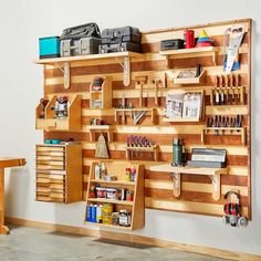 a wooden workbench with tools and other items on it's shelves in a room