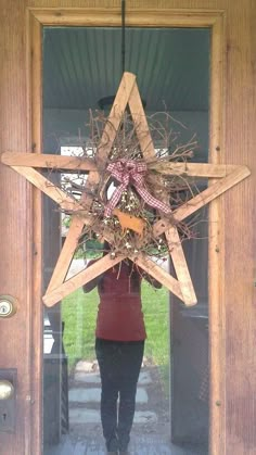 a person standing in front of a door with a star decoration on it's head