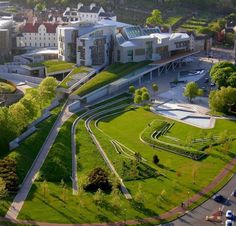 an aerial view of a building with green grass