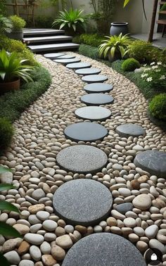 a stone path in the middle of a garden