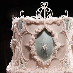 a fancy cake with white frosting and decorations