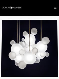 a chandelier with white balls hanging from it