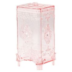 a pink glass cabinet with an ornate design on the front and bottom, sitting against a white background