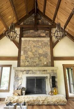 a living room filled with furniture and a stone fireplace