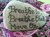 a rock sitting on top of a purple and black cloth with words written on it