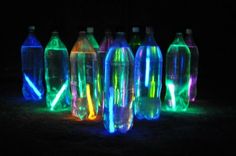 there are many bottles that have neon lights on them and the words put glow sticks in water bottles and play water bowling