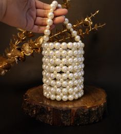 Elevate your bridal or party look with this stunning Round Pearl Beaded White Clutch Bag, designed to add a touch of elegance and sophistication to any outfit. This exquisite clutch is perfect for brides, bridesmaids, and anyone looking to make a statement at weddings, proms, or other special occasions. Handcrafted with shimmering pearls, this round clutch features a convenient handle, allowing you to carry it effortlessly. The luxurious pearl beading and secure clasp offer both style and practicality, making it an ideal accessory for any special day. White Bags With Pearl Handle For Reception, White Beaded Bag For Reception, White Pearl Embellished Bags For Reception, Cream Beaded Bags For Reception, Handmade Pearl Evening Bag For Wedding, Traditional White Evening Bag With Pearl Handle, White Pearl Embroidered Evening Bag For Reception, Handmade Pearl White Evening Bag For Wedding, Traditional White Bags With Pearl Handle