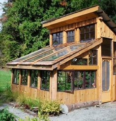 a small wooden building with lots of windows