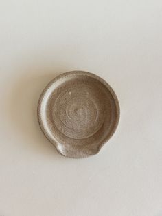 a small bowl sitting on top of a white table