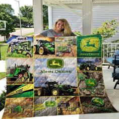 a woman holding up a john deere quilt