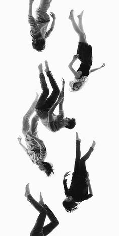 four people are jumping in the air with their legs spread out and one person is upside down