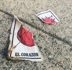 two pieces of paper that have been placed on the ground with words el coran written on them