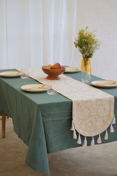 the table is set with plates and bowls on it