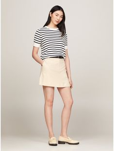 Tommy Hilfiger women's skirt. This mini skirt combines a playful silhouette with sophisticated details, such as understated logo embroidery above the back pocket.  Material: 66% Recycled Polyester (rpe), 32% Viscose (scv), 2% Elastane. Classic Spring Skort, Chic Mini Hem Skort For Work, Classic Summer Skort, Summer Classic Mini Length Skort, Classic Mini Length Skort For Summer, Spring Workwear Skort In Short Length, Relaxed Mini Skirt For Workwear, Classic Mini Skirt Skort For Summer, Summer Workwear Mini Hem Skort