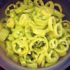 a bowl filled with green noodles and sliced banana's on top of each other