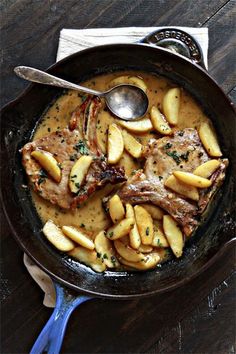 a skillet with some meat and potatoes in it