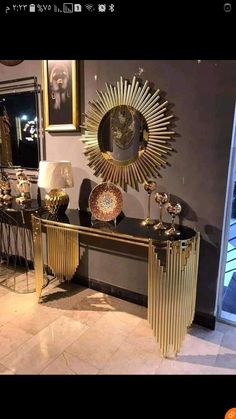 there is a gold and black console table in the room