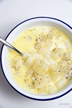 a white bowl filled with soup on top of a table