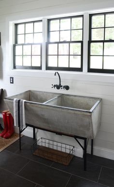 a kitchen with a sink, stove and window on the wall next to an oven