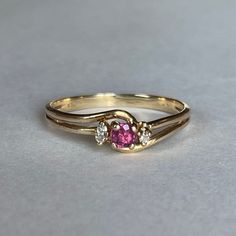 10K Gold Ruby and Natural Diamond Accent Ring, Size 7.75, 1.56 grams Beautiful Ring with Ruby center stone. One accent diamond stone is missing!  Size: 7.75 Weight: 1.56grams Main Stone: Ruby Color: Berry Pink Size: ca. 3mm dia. Secondary Stone: Natural Diamonds, 1.7mm dia. Marking: 10KP Gold: Yellow Gold Bandwidth: 2mm  Tested: Presidium Gemtester ll, Diamond Selector ll,  Olympus/Evident Scientific Vanta GX Precious Metals XRF Analyzer. Condition: Good preowned, 1 missing Diamond - Refer to pi Ring With Ruby, Unique Gold Jewelry Designs, Diamond Accent Ring, Gold Bride Jewelry, Gold Rings Fashion, Gold Ring Designs, Bride Jewellery, Gold Jewellery Design, Ring Size 7