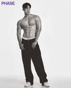 a man with no shirt standing in front of a white background and wearing black pants