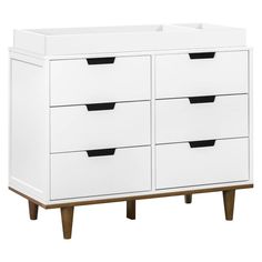 a white dresser with four drawers and wooden legs