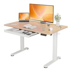 a computer desk with two monitors and a laptop on it's side, in front of a white background