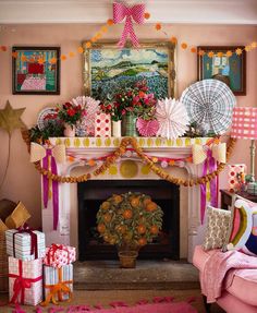 a living room decorated in pink and orange with decorations on the fireplace mantels