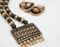 a black and gold beaded necklace with matching earrings