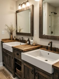 a bathroom with double sinks and wooden counter tops in the center, along with two mirrors above them