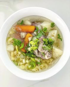 a white bowl filled with soup and vegetables