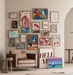 a living room filled with lots of pictures on the wall next to a chair and table