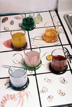 several cups sitting on top of a tiled table