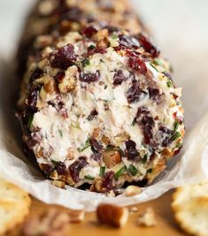 a cracker filled with cheese, nuts and cranberries