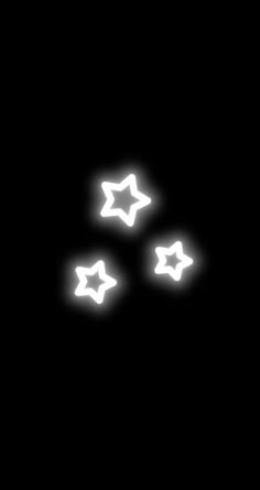 three white stars are glowing in the dark