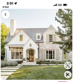 a house with two windows and white trim on the front door is shown in an instagram