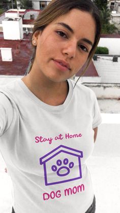 a woman wearing a t - shirt that says stay at home dog mom